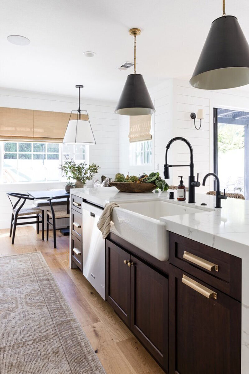 Kitchen with marble countertops and natural textures in a cozy coastal cottage in Costa Mesa CA
