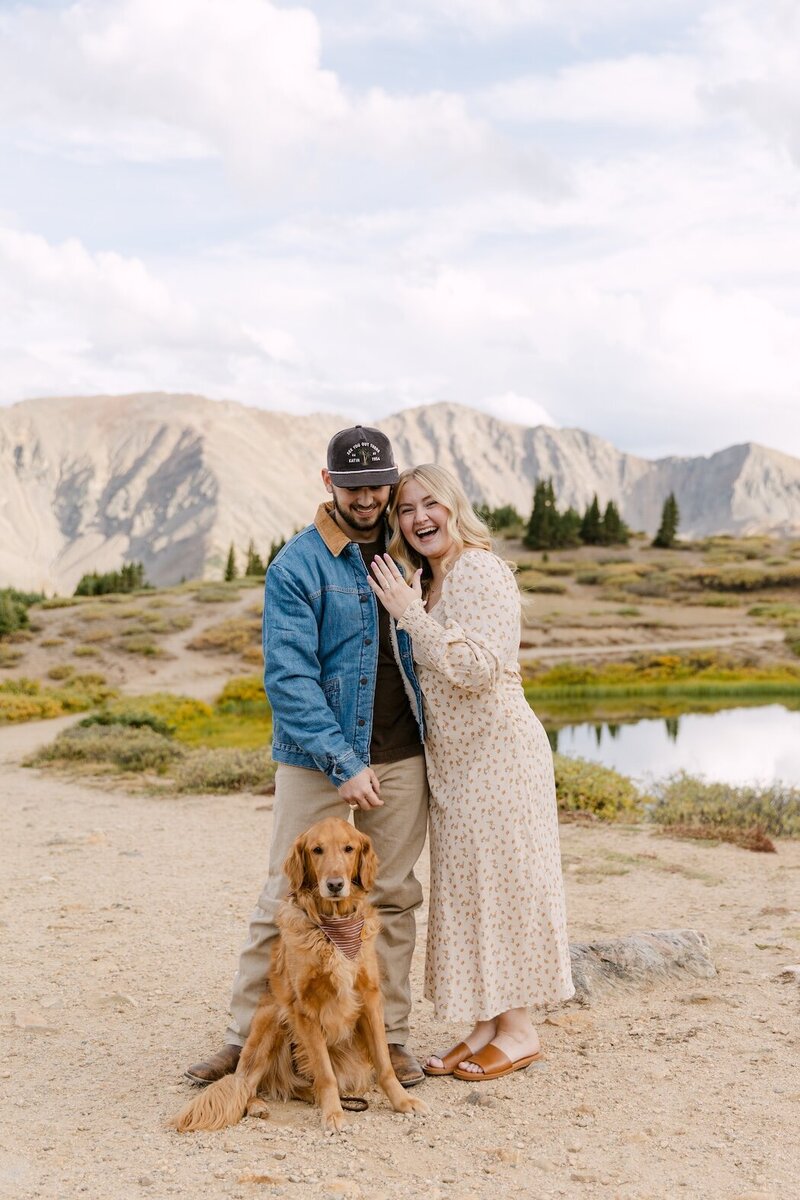 Surprise proposal in Colorado alpine meadow with couple and their golden retriever at sunset | Colorado proposal photographer