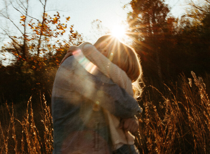 Couple hugging at sunset