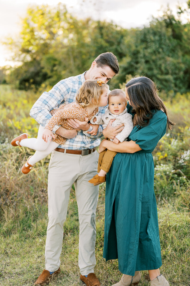 Family with two young children and play together during Fall family photo session