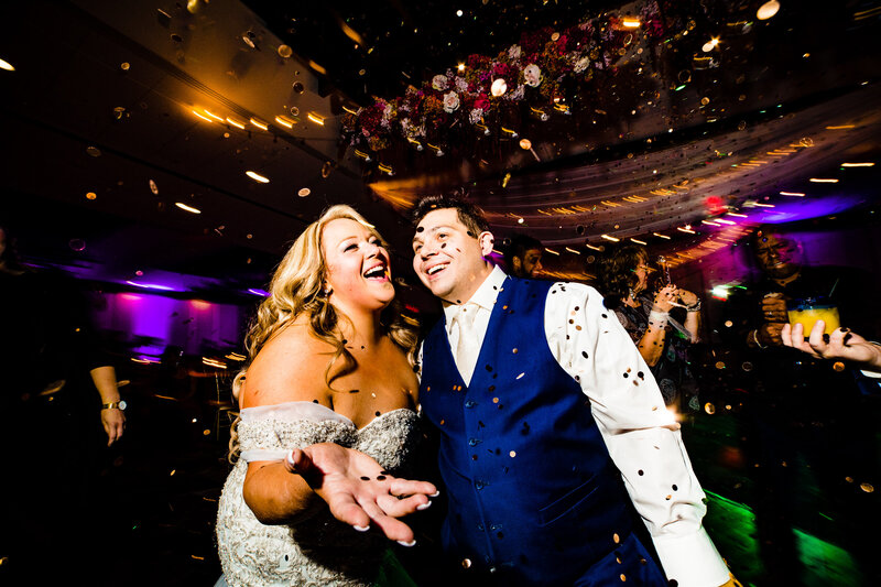 A wedding couple in Detroit smiling as they walk down the aisle after their wedding