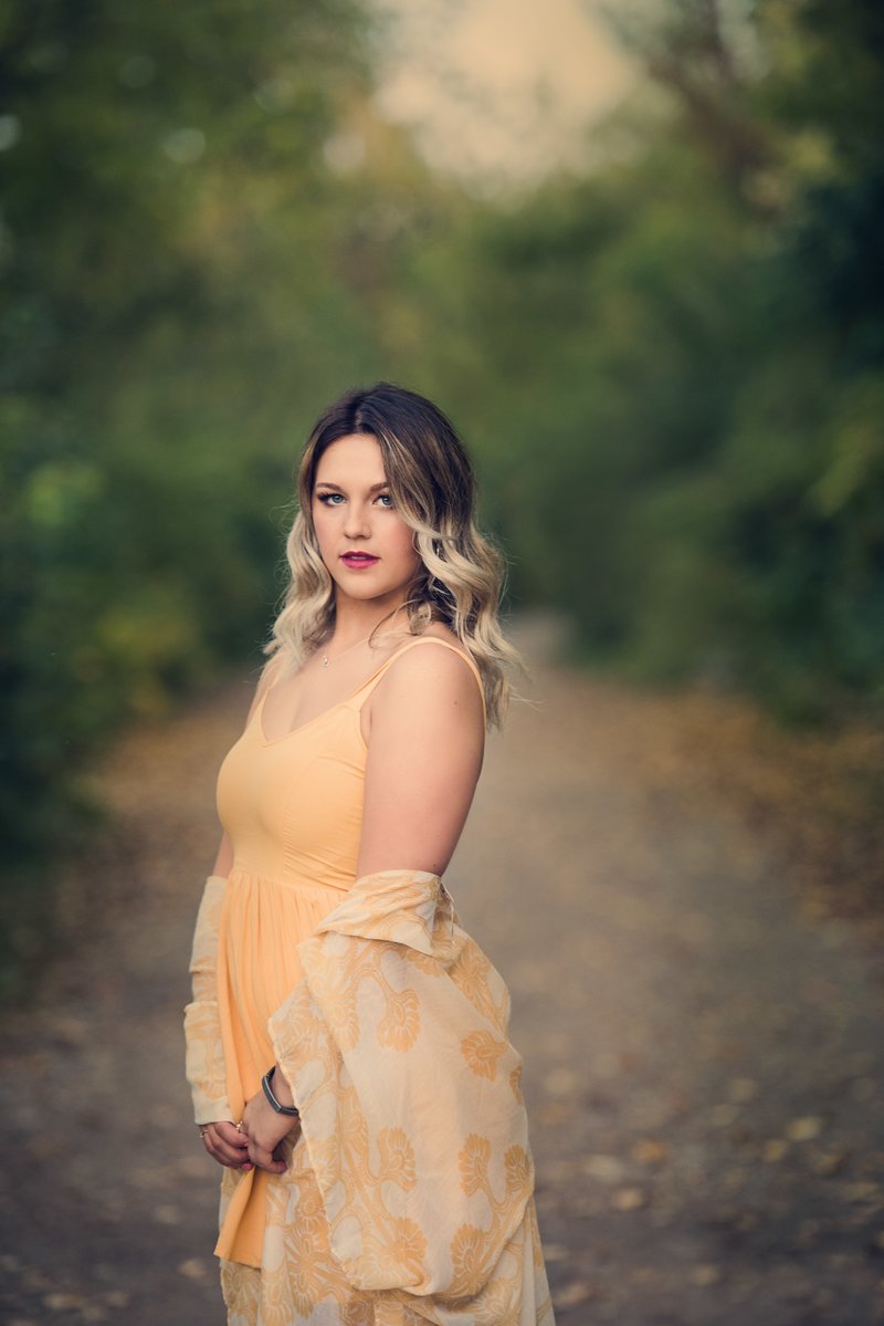 girl in yellow dress and wrap in trees