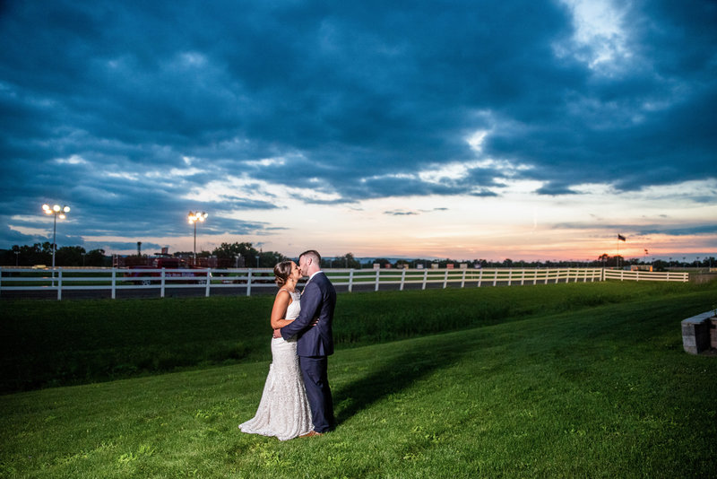 Picture of a bride and groom during sunset at Vernon Downs Horse Racing Track