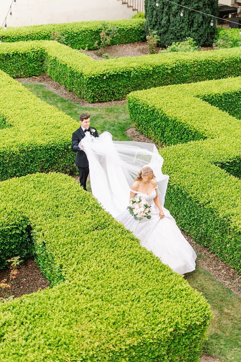 Bride and groom walking through a maze garden in Monterey, California by Wedding Photographer, Sherr Weddings.