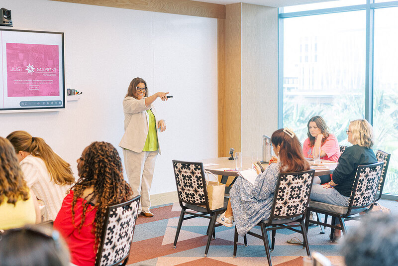 Event planner presenting to room of conference attendees