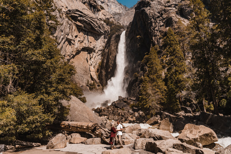 couple saying vows in front of lower yosemite falls