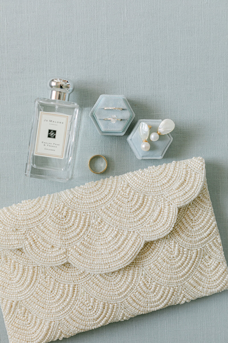 Soft blue linen flat lay mat styled with romantic paper goods and silk ribbon