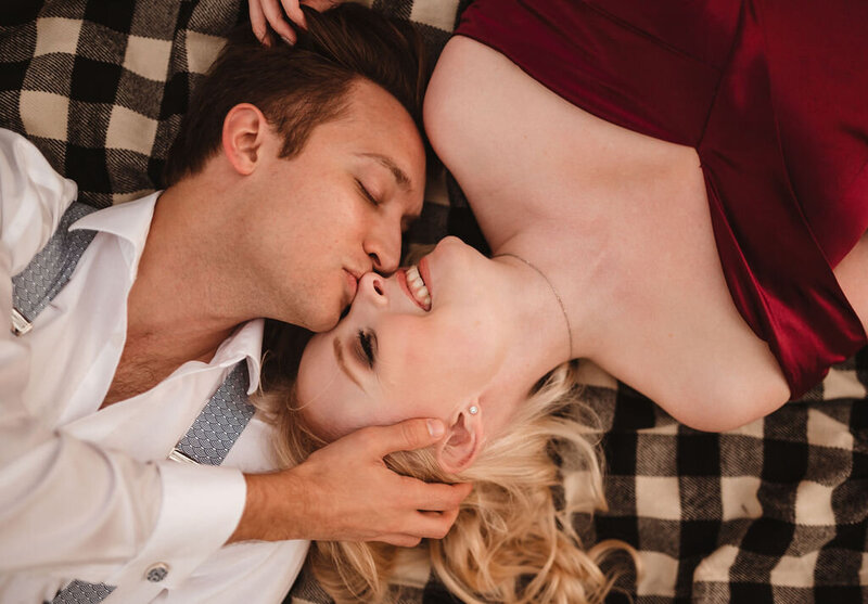Couple lying down together on a blanket during an outdoor session near Doylestown, Pennsylvania