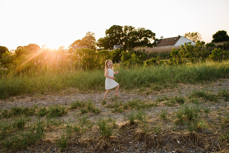 child running on beach at sunset