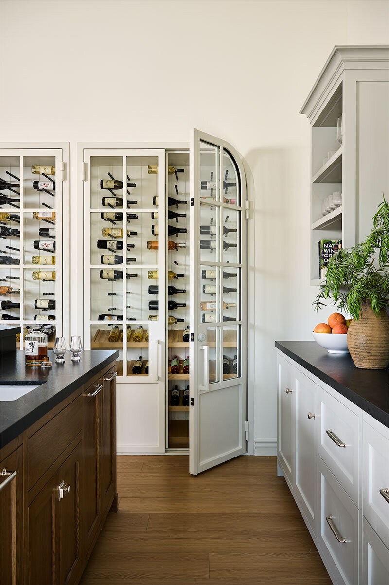 Home bar with Built-in wine cellar and livable luxury and neutral tones in a Orange County renovation
