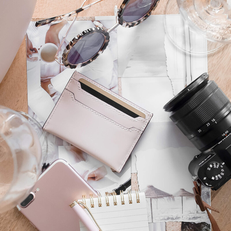 Overhead view of a wedding photographer’s desk with coffee, glasses, and an open notebook, symbolizing HoneyBook workflows that support organization and clarity.