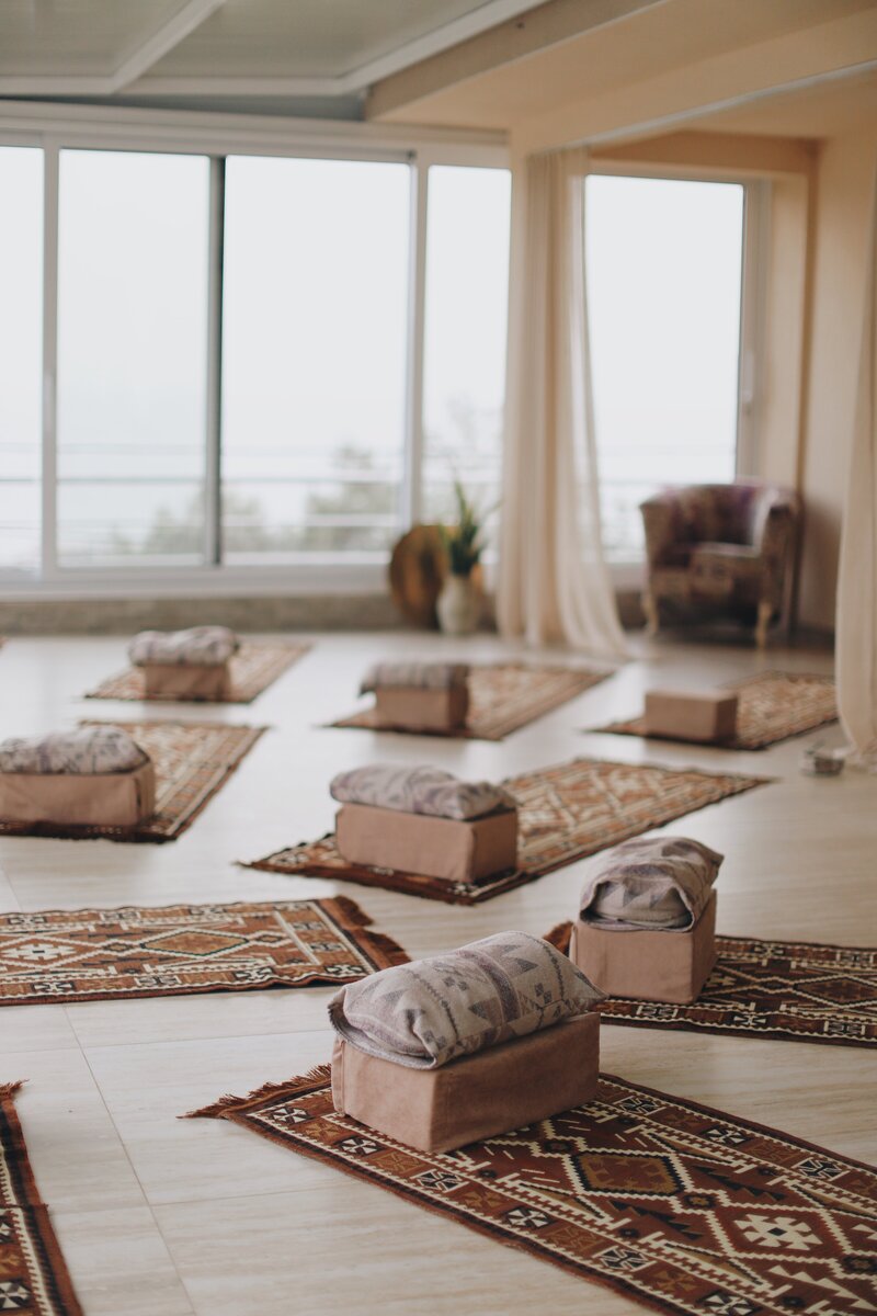 Yoga mats and props setup for practice in yoga retreat