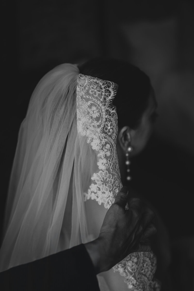 A wedding photographer captures the magical moment of a bride and groom celebrating their wedding ceremony as the bride throws the bouquet in the air