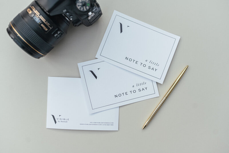White notecards and camera with pen for premium branding