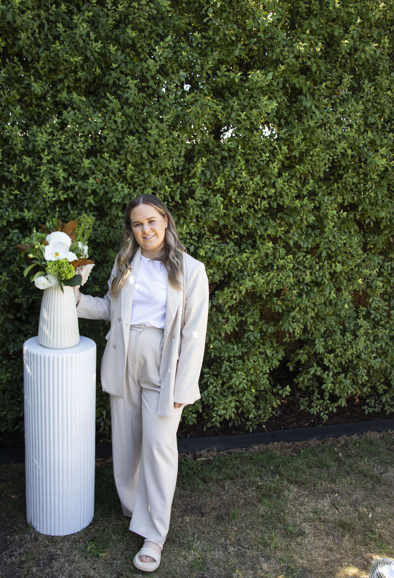 Owner of forever and a day with a styled floral arrangement at a wedding. 