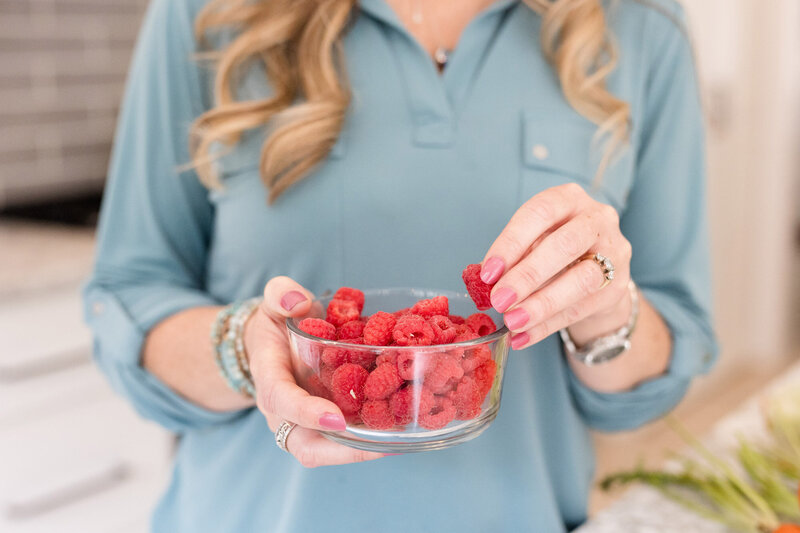 Amy eating a bowl of raspberries