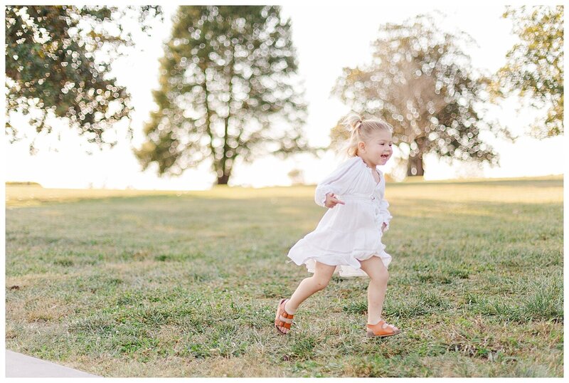 Knoxville family photo of young kid running in grass at Lakeshore Park