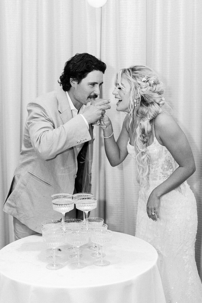 Wedding couple celebrating with champagne captured in Miami, Florida by Claudia Amalia, a wedding and lifestyle photographer based in Miami and Florida Keys, South Florida. She also does destination weddings. Portfolio highlight.