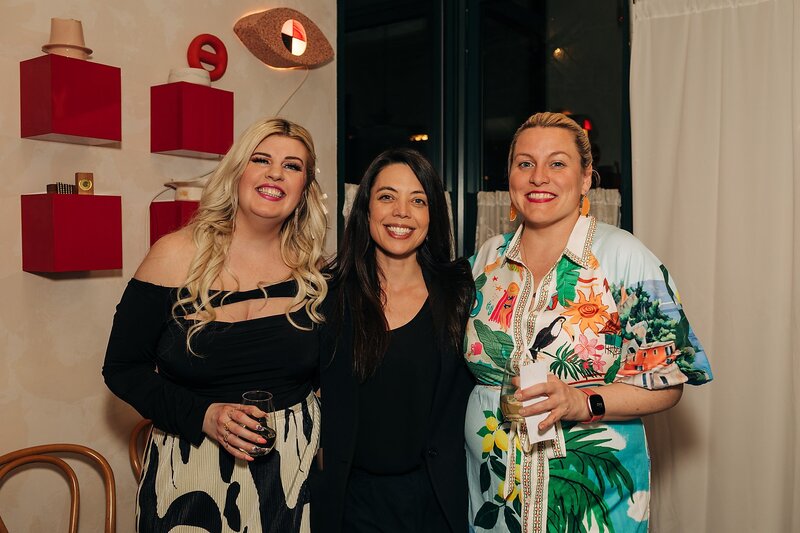 Friends toasting and celebrating during Dart Collective Chicago launch at Lou Lou by Lola Cafe