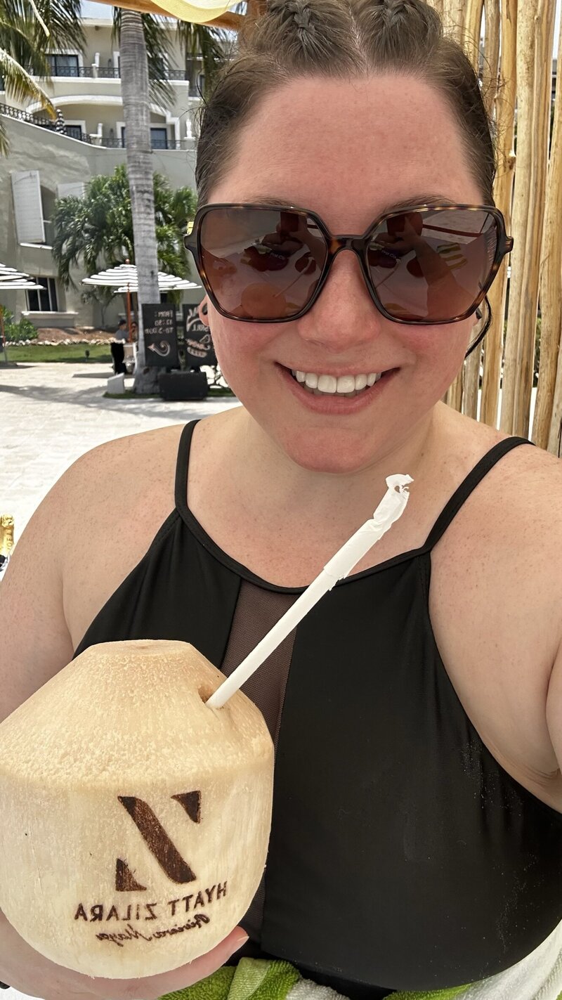 Dana drinking coconuts during destination research