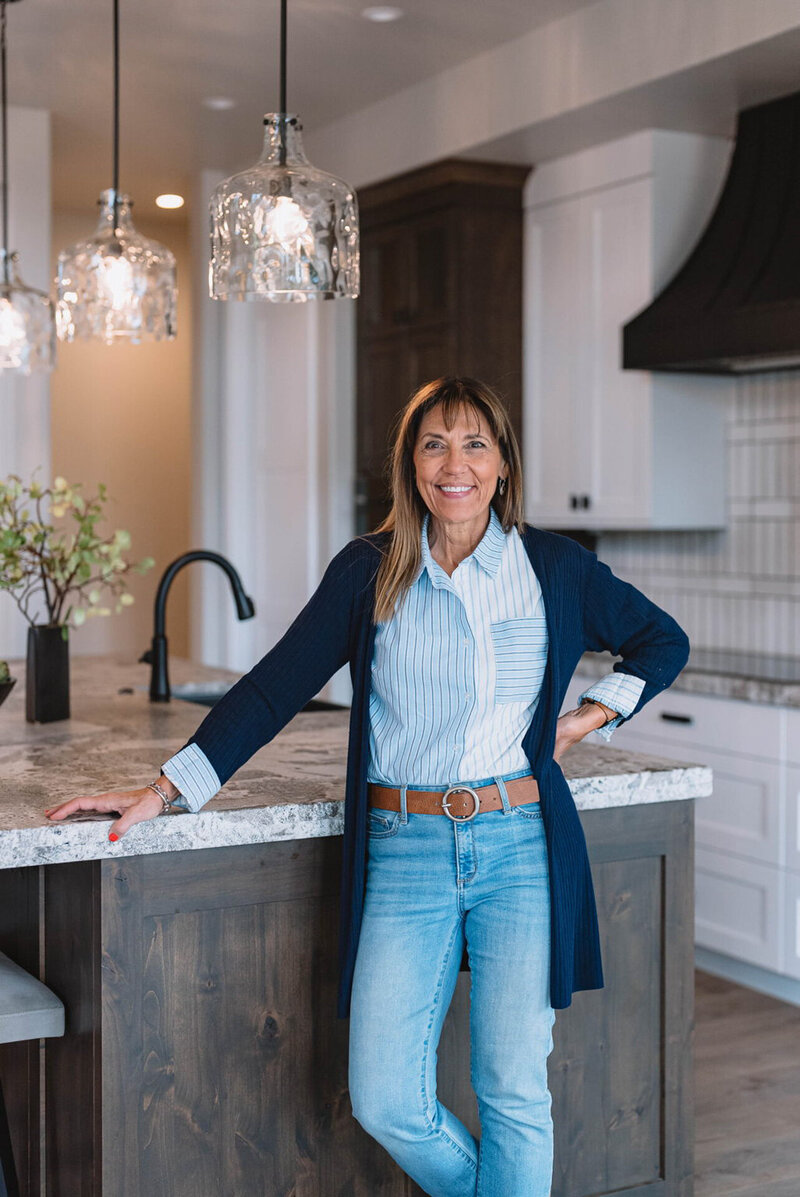 Stephanie Sarro, a Coeur d'Alene Interior Designer and owner of Sarro Design, standing in front of one of her kitchen remodels.