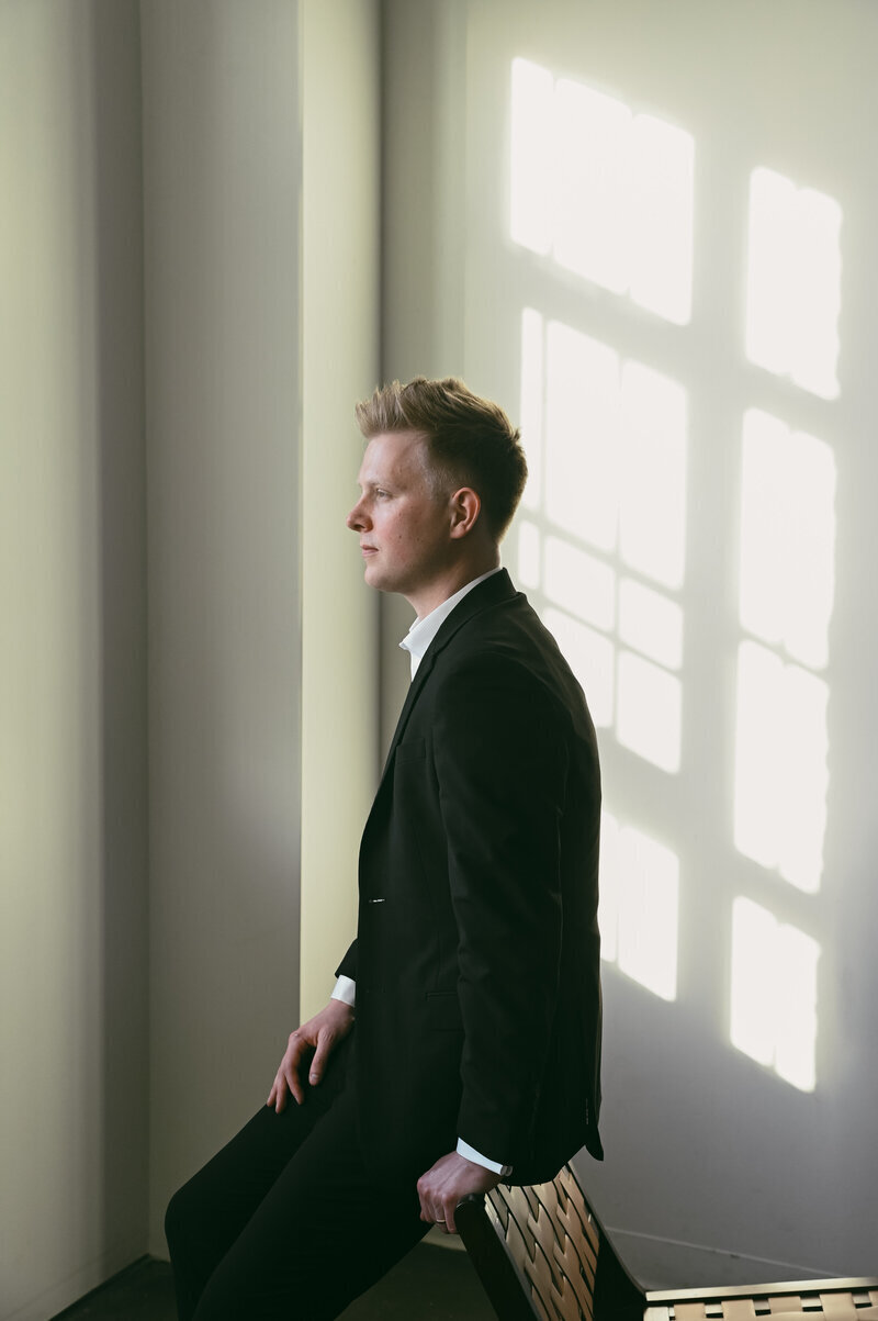 Milwaukee wedding planner Quintin Jancola looking out window