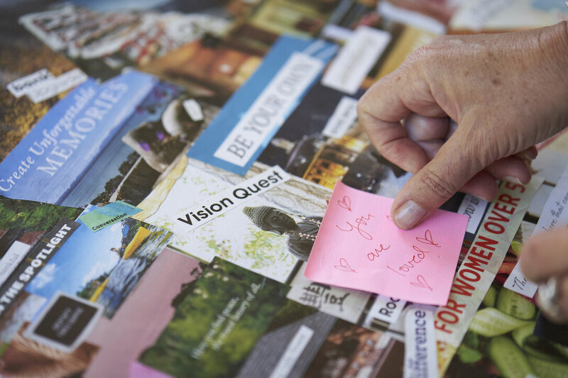 Hands adding a loving affirmation to a vision board, reflecting subconscious reprogramming, emotional healing, and the power of belief
