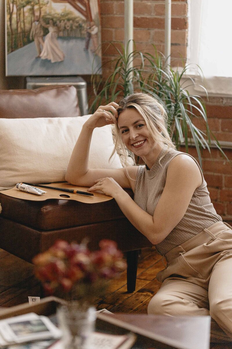 Steph posing in studio with art supplies