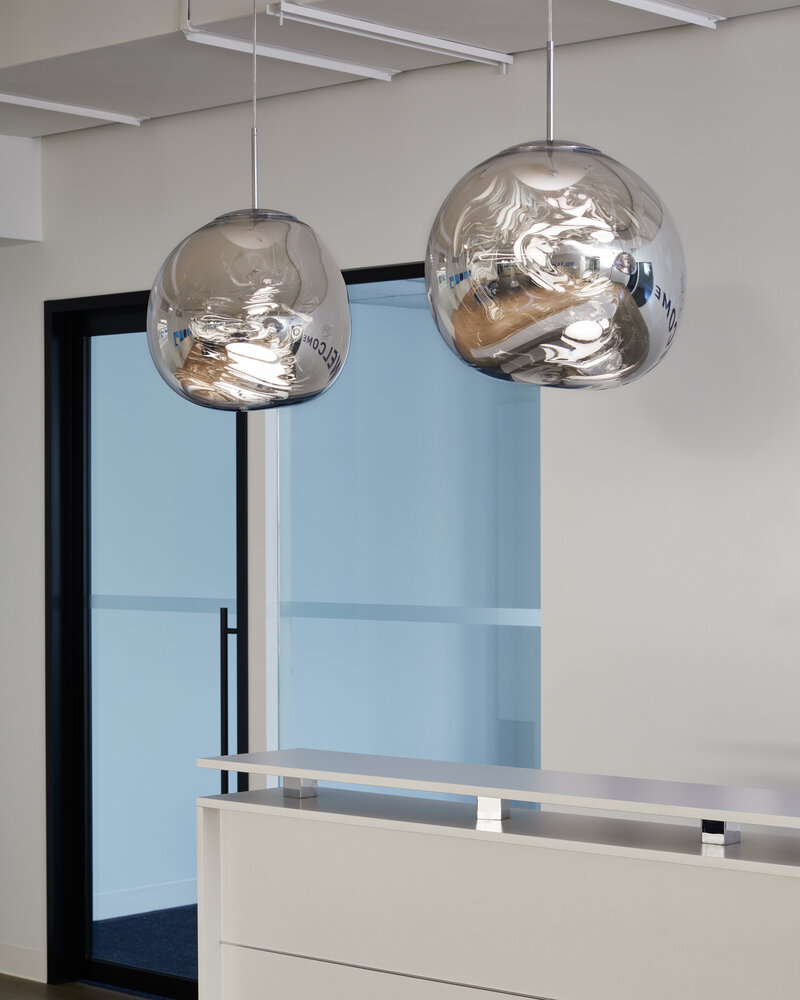 Custom circular pendent light installations over riser seating