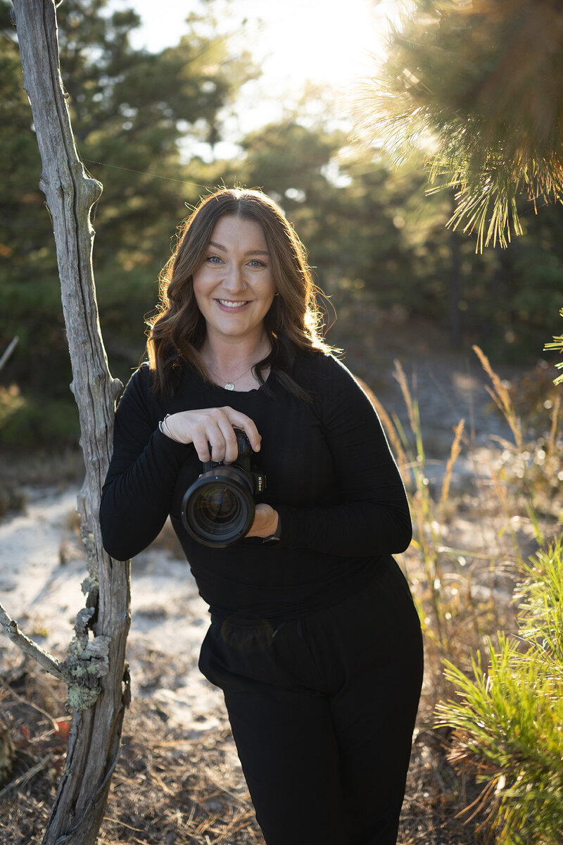 Cat Barnes Photography holding a camera 