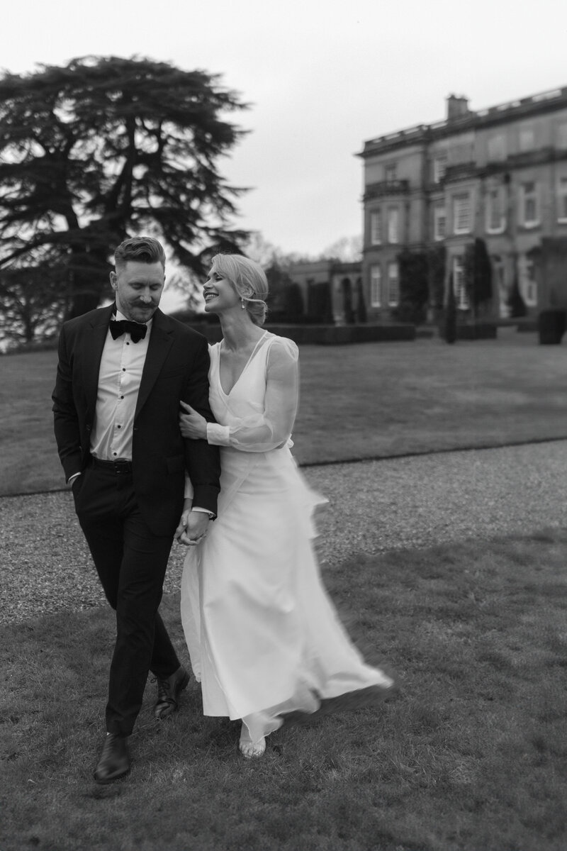 A wedding photographer captures the magical moment of a bride and groom celebrating their wedding ceremony as the bride throws the bouquet in the air