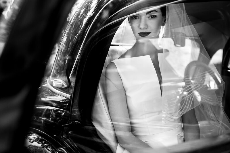 Bride in black and white phote in a classic car