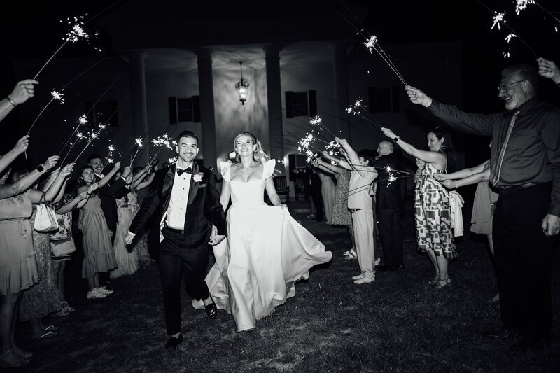 Black and white photo of bride and groom sparkler exit taken by 35mm film wedding photographer Noble Photo Co