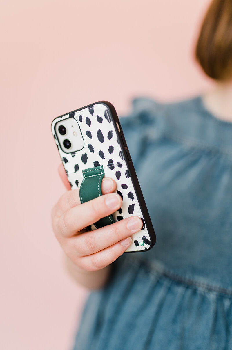 Copywriter Sara Gillis holding her cell phone