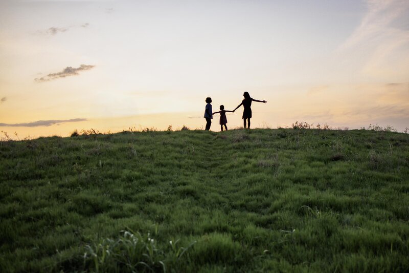a sunset image of three kids in plano
