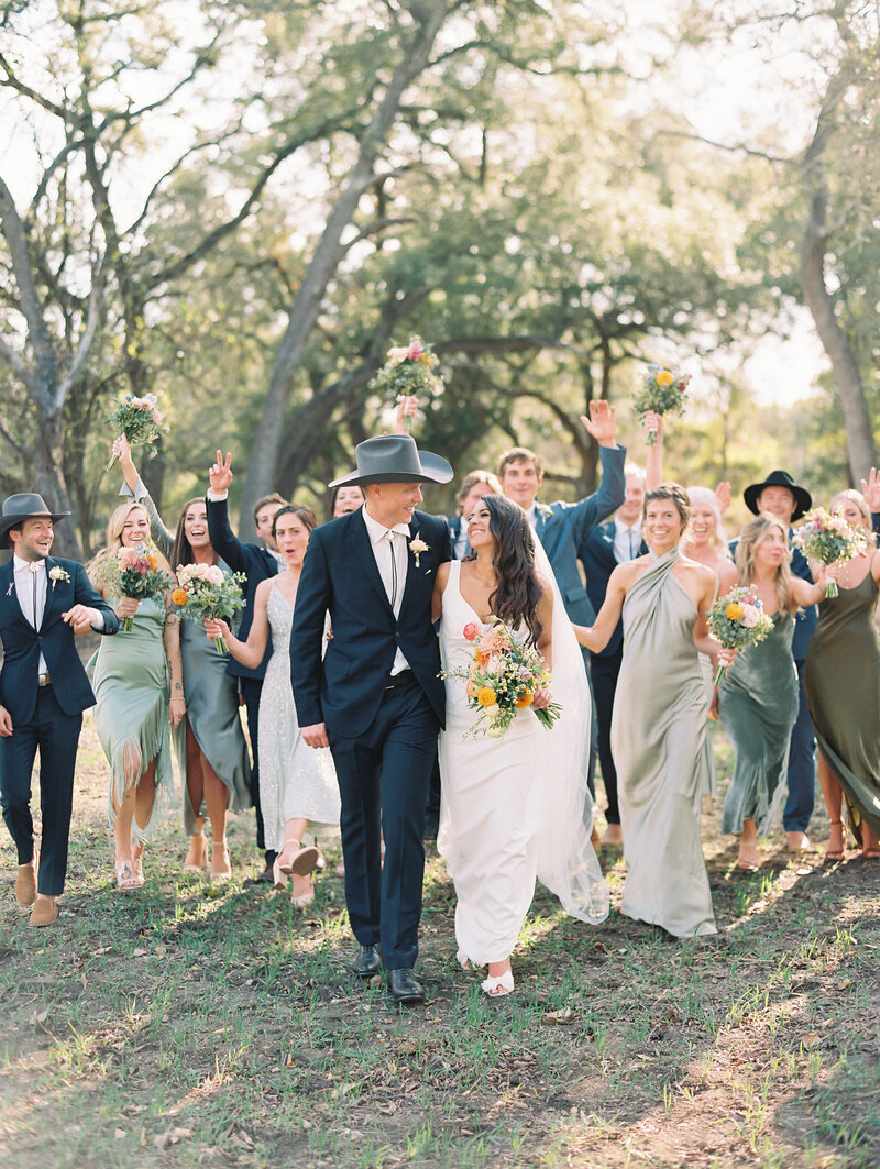 Bride and groom walking with their wedding party