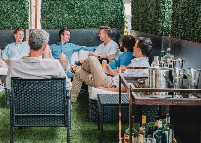 group of men sitting around talking