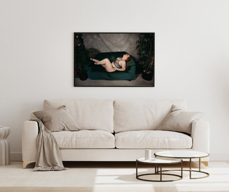 A black framed wall art piece  of woman laying on a coach with lingerie in Minneapolis Mn