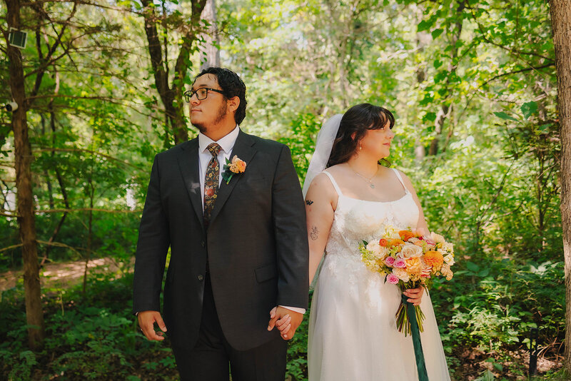 bride and groom pose at wedding venue in oklahoma