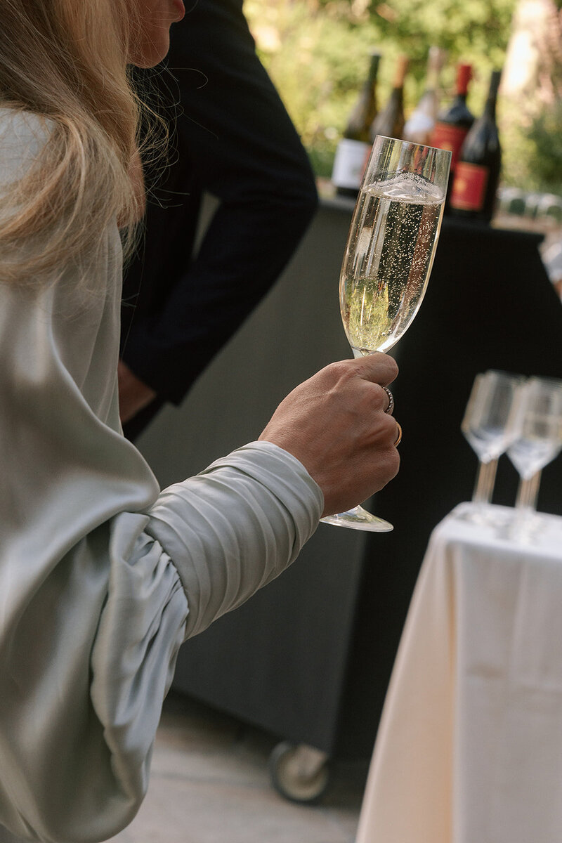 Wedding guest holding champagne glass