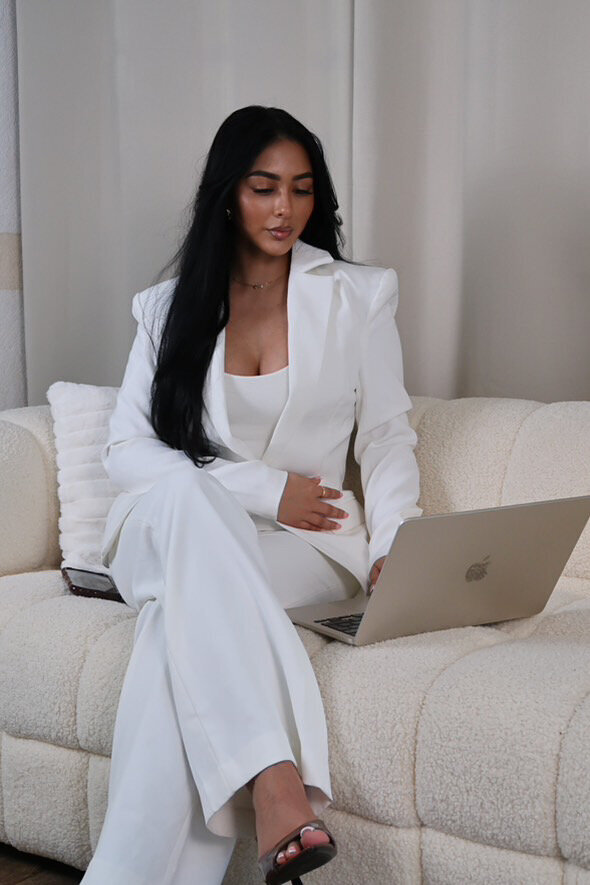 Women on cream sofa in casual wear on the phone 