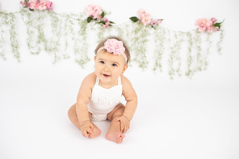 Baby girl sitting for milestone session by Maryland Portrait Photographer