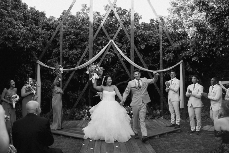 Bride and groom celebrating after saying "I do" in black and white documentary photo | Sush Digital Media