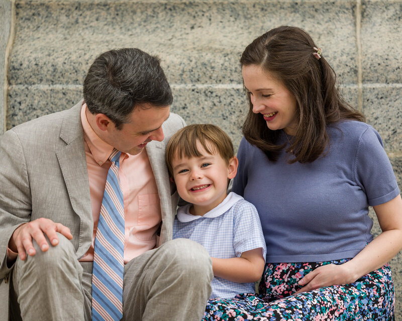 A little boy in colorful spring attire laughing joyfully while posing at Valley Forge.