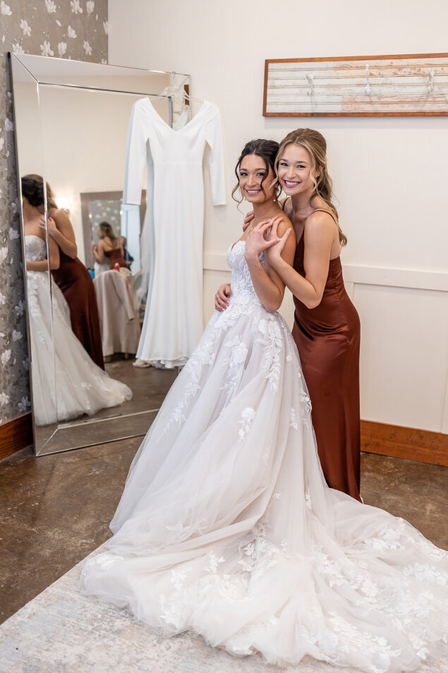 A bride with a bridesmaid inside the bridal suite.