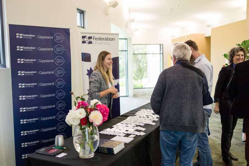 Casey Bonacci greets guests to Federation University Gippsland 50th Anniversary Event