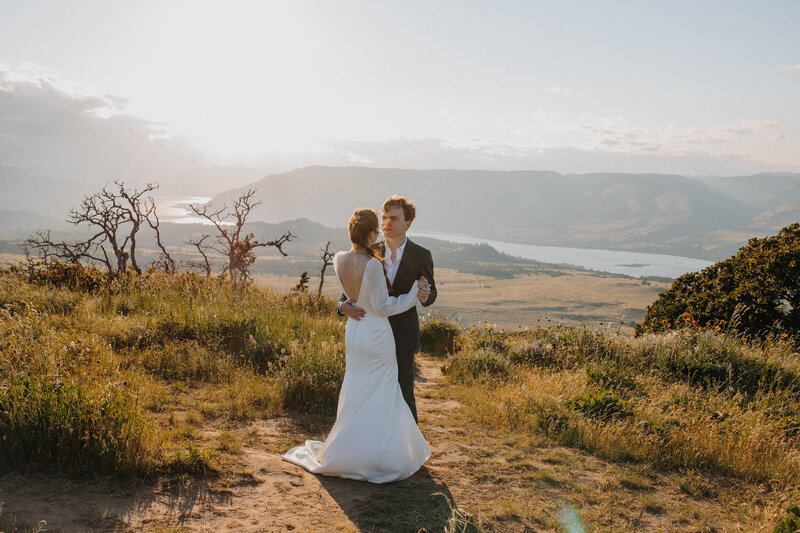 Bride and groom dancing on a mountain top
