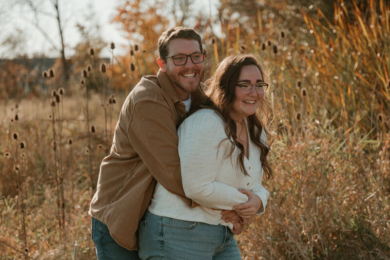 photo of man hugging woman from behind