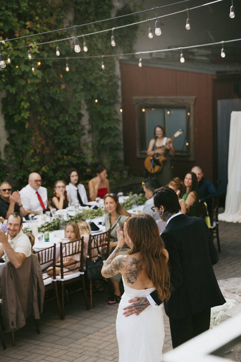 bride and groom celebrate after their first dance with their guests at their alberta wedding
