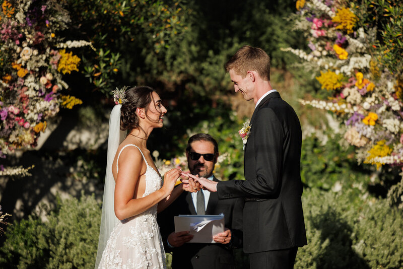 couple exchanging rings at their wedding ceremony
